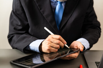 close up businessman hand electronic signature on tablet by stylus - business man writing on...