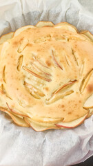 Delicious homemade apple pie baking on baking paper