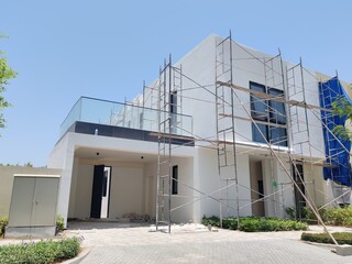 Under Construction luxurious House Or Villa's outdoor view.
Exterior View Of 02 Story Incomplete House With Modern Design.
White Color UnComplete Villa Structure with Erected Scaffolding Pipes around.