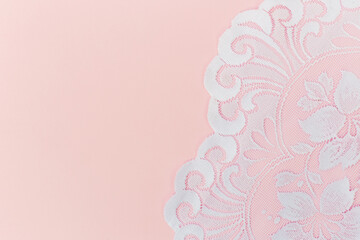 White Lace Fabric on Soft Pink Background. Copy space