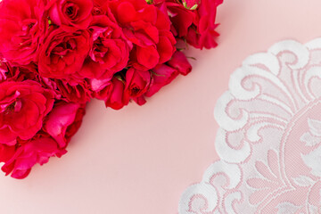Pink Roses and White Lace on Blush Background. Flat lay