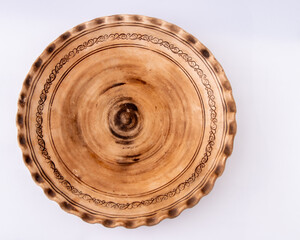 Hand Carved Decorative Ceramic clay plate on white top view. Empty dish