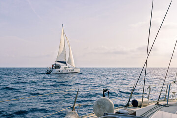 Sailing boat in the sea with white sail. Sailing regatta. Sailboats in Mediterranean sea, luxury yacht.
