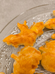 Halloween bat cookies resting on elegant glass platter