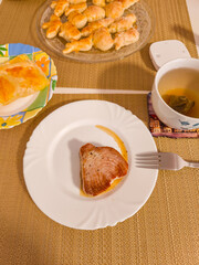 Grilled tuna steak served on white plate with dessert and tea