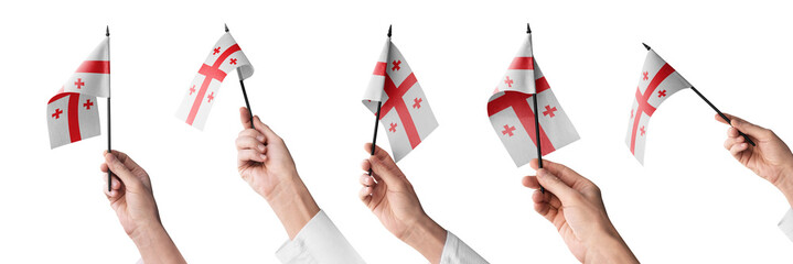 The Georgia flag in hand in different angles on a white background
