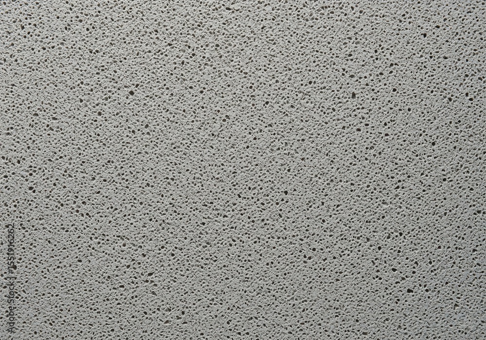 Poster porous grey textured background. this abstract image features a close-up of a coarse, neutral-toned 