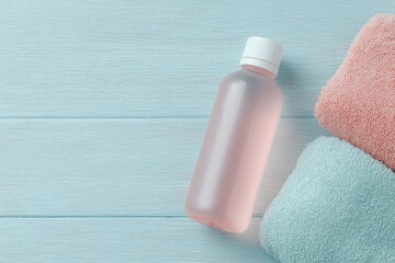 flat-lay of water-infused fruit drink towel fitness gloves beside stepper pedal on wood floor