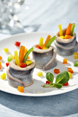 Herring pieces served on light blue background