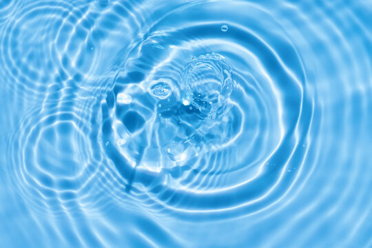 Water background,Blue water on pool.Sea ocean wave surface with light effect,Clear water splash motion with circle pattern and abstract drop in bathroom,Nature spring freshness Zen for spa, cosmetic