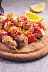 Delicious grilled chicken skewers with capsicum, lemon, salad and ketchup on a plate over the table. Chicken kebab. Healthy food concept.