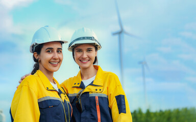 Two beautiful female engineering colleagues and alternative technology engineers surveying wind...