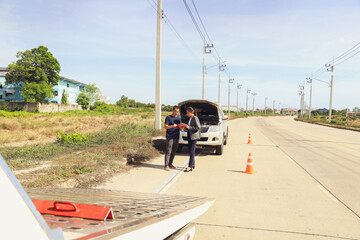 Wide angle Female officer from car insurance company stands crosses her arms help take care damaged...