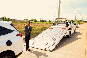 Asian businesswoman car broke down while traveling uses smartphone contact help emergency service...