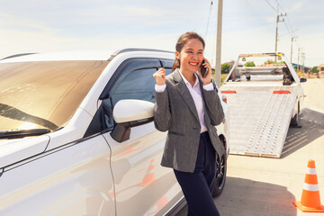 Happy asian businesswoman car broke down while traveling uses smartphone contact help emergency...