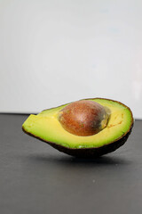 half avocado with black background