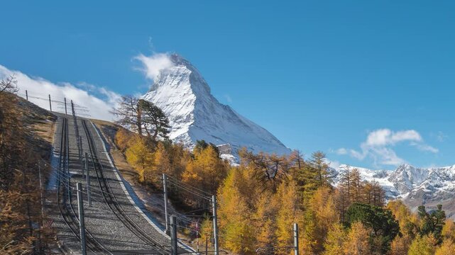 Zermatt Switzerland time lapse of Matterhorn mountain peak and Gornergrat bahn train in Autumn Season
