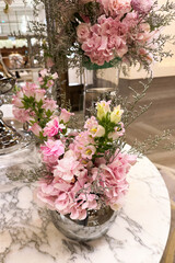 Beautiful flower arrangement in a glass vase on a marble table in an elegant setting