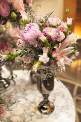 Elegant floral arrangement in a decorative vase at a luxurious venue