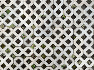 Close up of molded grey paving stone in diamond pattern. This diamond shape paving is used mostly...
