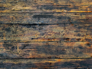 Obraz premium Close up of weathered and rustic solid wood texture with black veins. Weathered textured timber wooden plank and deck in industrial vintage color. Seamless background texture.