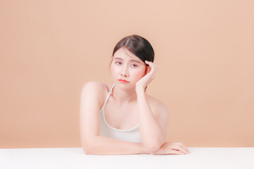 Portrait young asian woman sitting and thinking stressed about taking care of her health and skin...