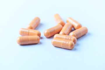 Calcium carbonate capsules. Bright paper background. Soft focus. Close up. Copy space.	