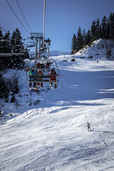 Obraz premium Family on a chairlift, Megève ski resort, Haute-Savoie, France