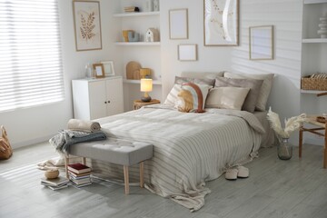 Comfortable bed with soft linens in room. Home textile