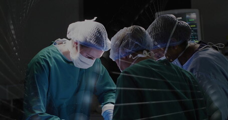 Performing surgery by three surgeons in hospital operating room, with monitor and instruments