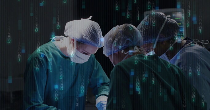 Operating surgical team in green gowns performing procedure in OR, with data overlay visuals