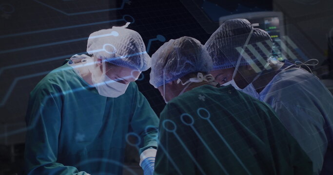 Performing three surgeons in green gowns operating in OR with lamp, draped patient, data overlay