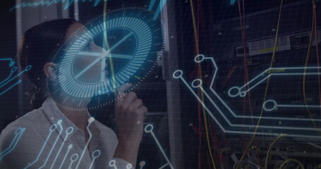 IT engineer analyzing overlays and inspecting racks with patch cables in data center, copy space