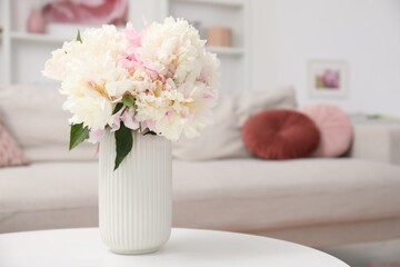 Bouquet of beautiful peonies on table indoors. Space for text