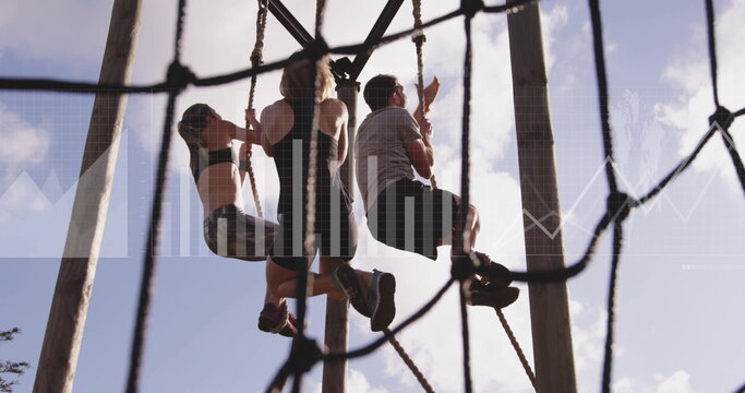 Climbing trio of friends scaling ropes at outdoor ropes course, with rope netting and wooden poles