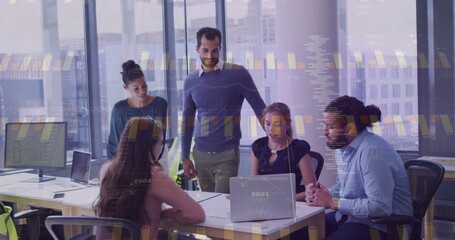 Collaborating five professionals analyzing data at high-rise office, with laptops and paper charts