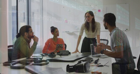 Discussing drone assembly, team leaning over table in office with frame and VR headset