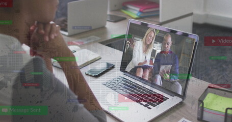 Leaning forward adult man watching laptop at home office, with notebook tablet tray, copy space