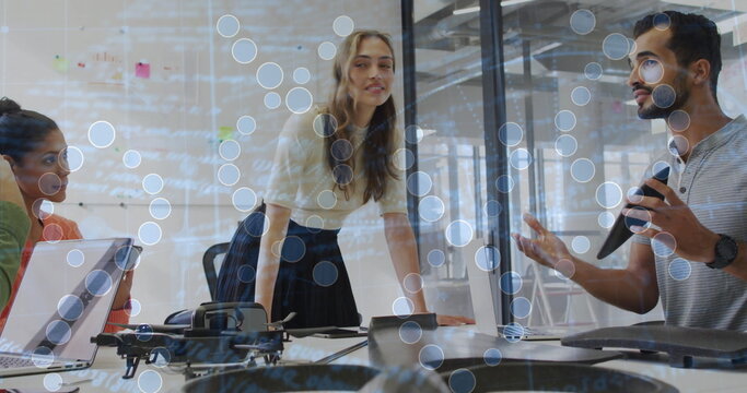 Team of professionals conducting meeting in glass conference room, with drone notebooks microphone