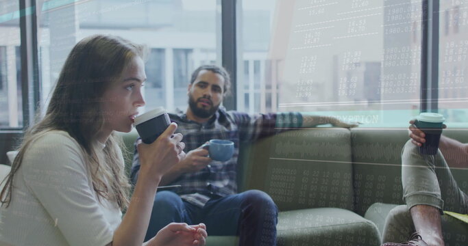 Sitting colleagues drinking from takeaway cups and ceramic mug on sofa in office lounge, by windows - Powered by Adobe