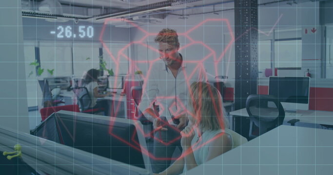 Business casual coworkers reviewing red data hologram in office with red partition panels