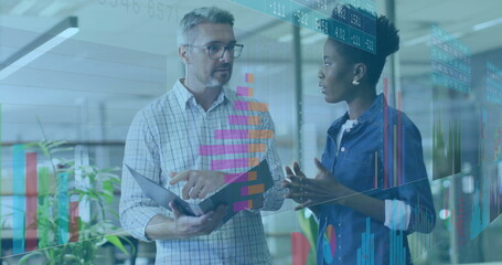 Pointing coworkers analyzing data projections on glass partition at office, tablet and charts