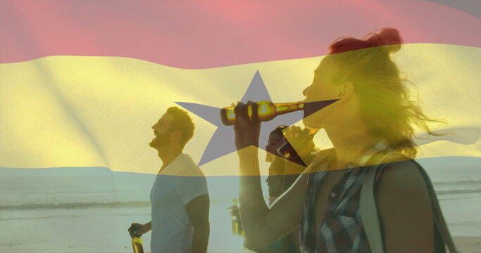 Naklejki Walking five friends holding glass bottles along sandy beach at sunset, with flag overlay