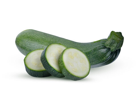 Fresh green zucchini sliced into circles on the cutting against the same whole on transparent.