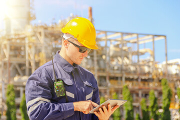Male engineer worker in hard hat inspects work platform on tape measure standing safety inspection...