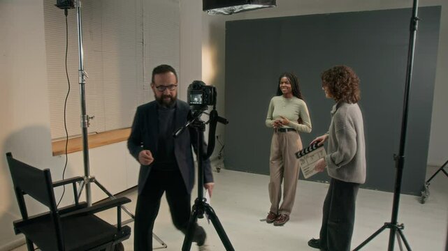 Full shot of filming director giving tips to African American actress before filming her acting auditions