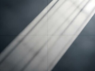 Soft shadows of fence spikes cast on a smooth concrete wall, creating a minimalist and moody abstract pattern.