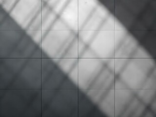 Soft shadows of fence spikes cast on a smooth concrete wall, creating a minimalist and moody abstract pattern.