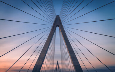 Obraz premium Symmetrical Cable-Stayed Bridge Architecture Against Sunset Sky
