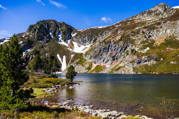 Blue Lake at the foot of Sarrat de Gabensa and Roc de Bragues in spring, with the last snow